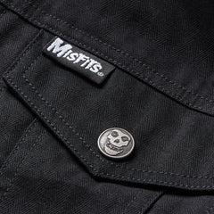 Black denim jacket pocket featuring Misfits label and skull button on Sherpa collar jacket