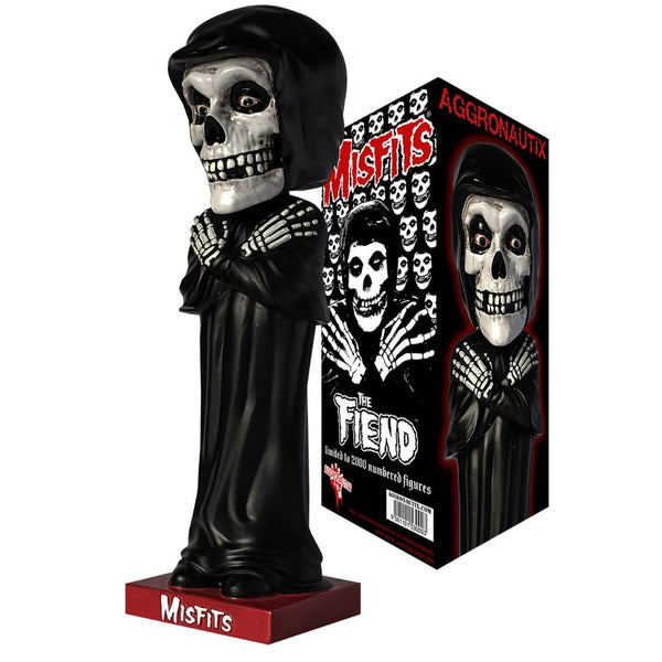 Skull-faced bobblehead in black robes next to Misfits Fiend Limited Edition packaging