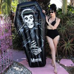 Black coffin-shaped Misfits Pool Float with skeleton design and logo